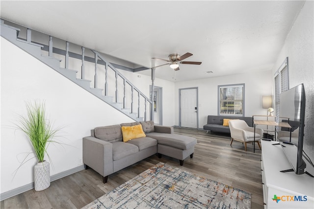 living room featuring wood-type flooring and ceiling fan