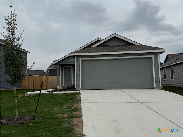 ranch-style home featuring fence, a shingled roof, a front lawn, a garage, and driveway