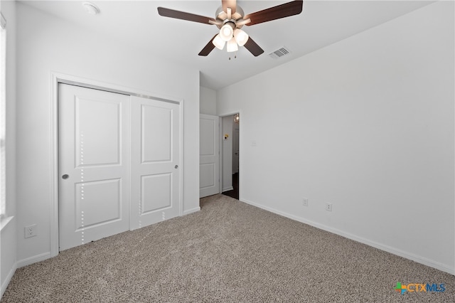 unfurnished bedroom featuring ceiling fan, carpet floors, and a closet