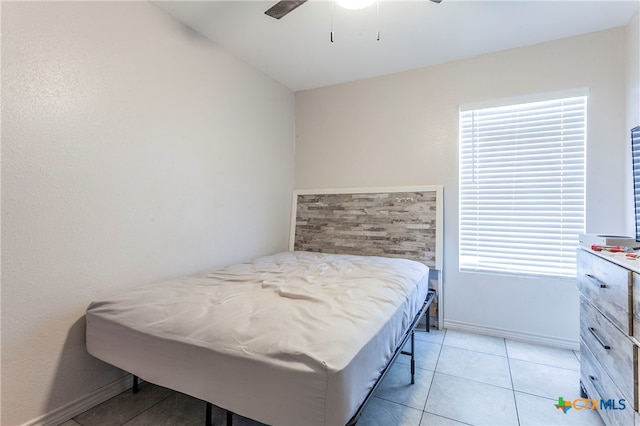 tiled bedroom with ceiling fan