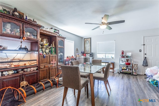 dining area with wood-type flooring and ceiling fan