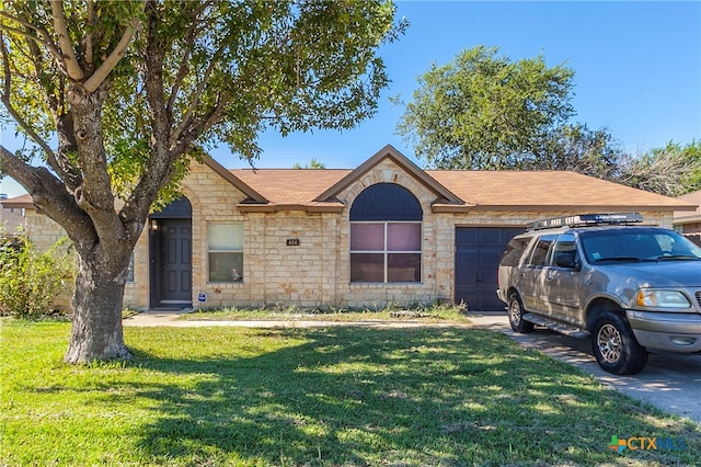 ranch-style home with a garage and a front yard