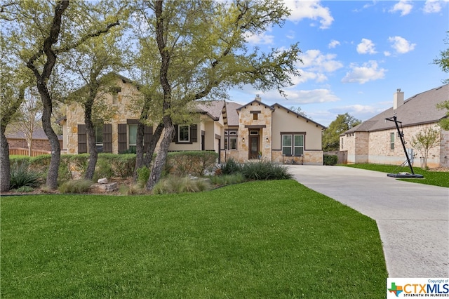 mediterranean / spanish house featuring a front lawn