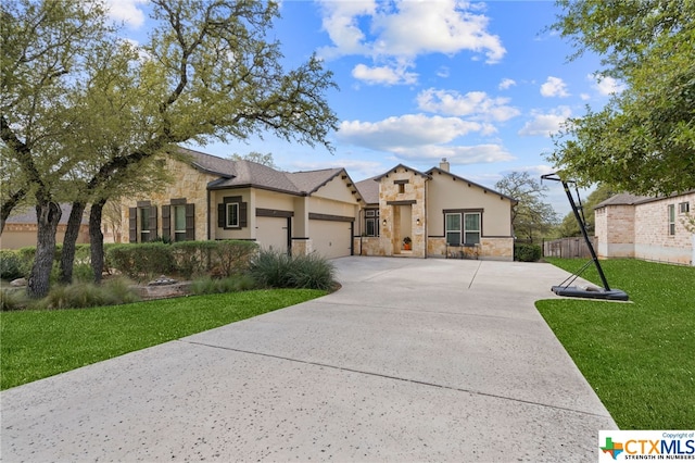 view of front of property featuring a garage and a front lawn