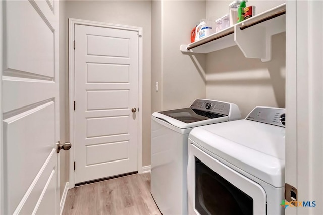 213 Flint Rock Ct, Victoria, TX 77904 - laundry area with separate washer and dryer and light wood-style flooring