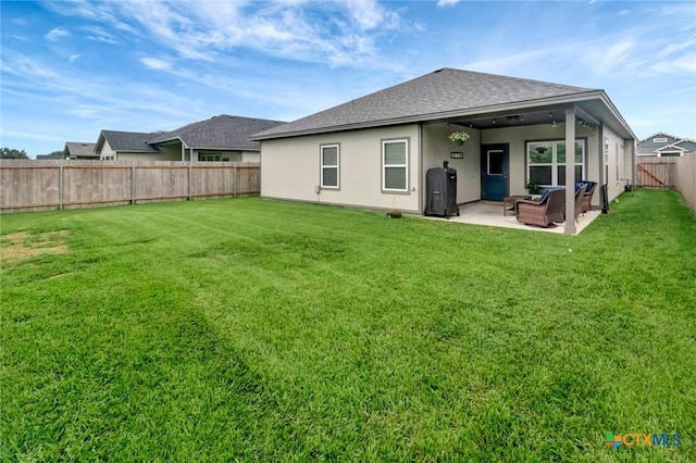 213 Flint Rock Ct, Victoria, TX 77904 - back of property with a fenced backyard, a shingled roof, a patio, an outdoor living space, and stucco siding