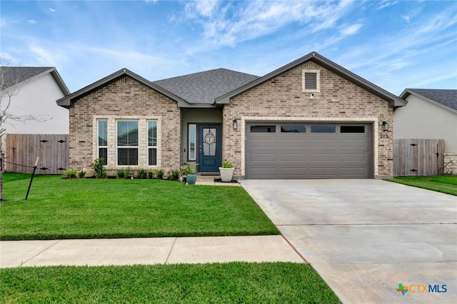 213 Flint Rock Ct, Victoria, TX 77904 - view of front of property featuring brick siding, an attached garage, concrete driveway, and a gate