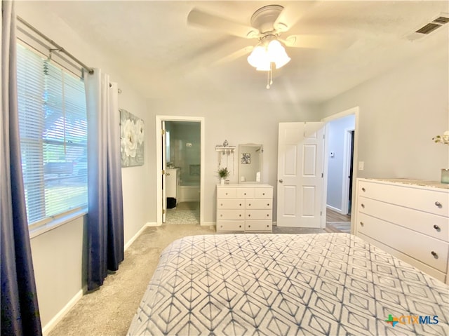 unfurnished bedroom featuring light colored carpet, ceiling fan, and ensuite bathroom