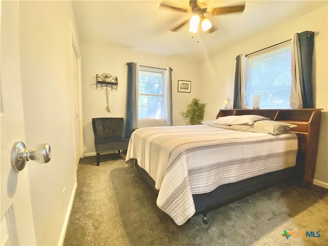 bedroom featuring ceiling fan and dark colored carpet