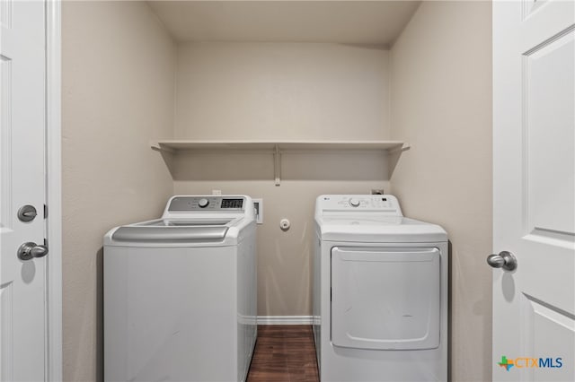 washroom featuring washer and dryer and dark wood-type flooring