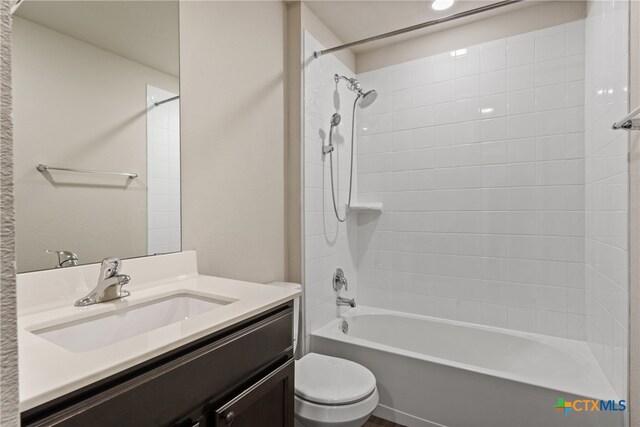 full bathroom featuring vanity, toilet, and tiled shower / bath