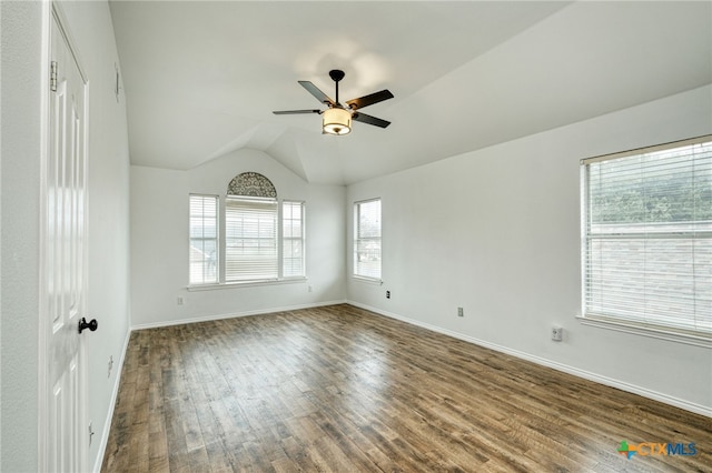 empty room with ceiling fan, dark hardwood / wood-style flooring, and lofted ceiling