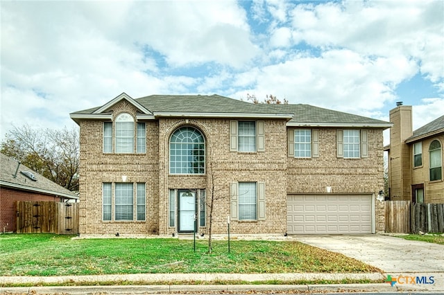 view of front of home with a front yard and a garage