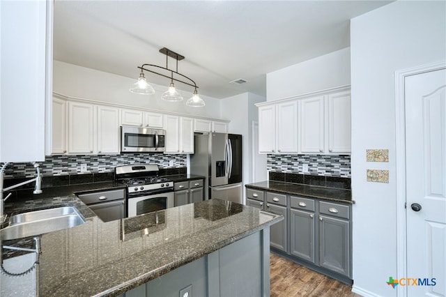 kitchen featuring sink, white cabinetry, stainless steel appliances, and dark wood-type flooring