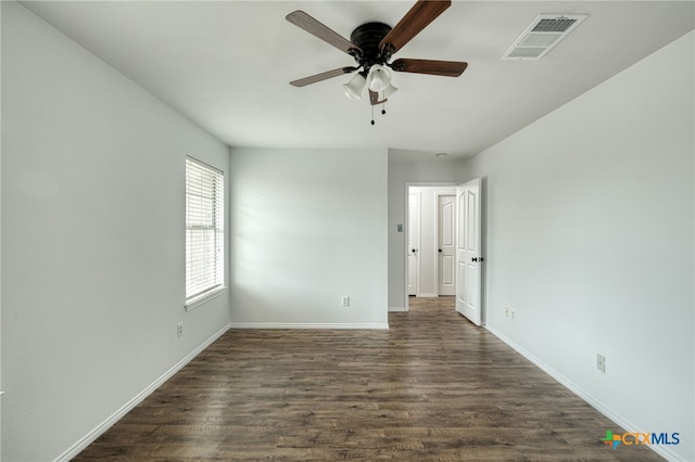 unfurnished room with ceiling fan and dark wood-type flooring