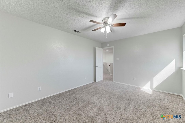 unfurnished bedroom featuring visible vents, baseboards, a textured ceiling, and carpet flooring