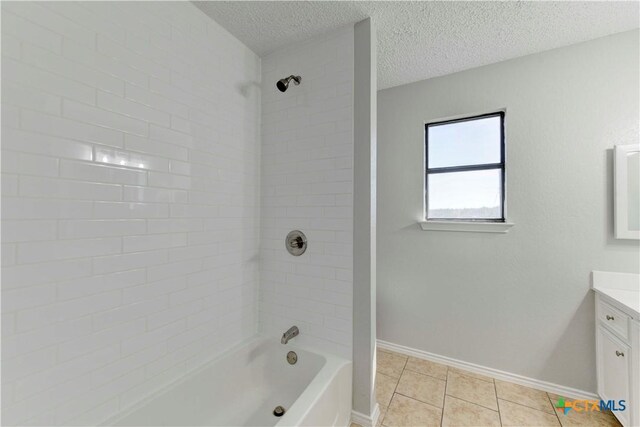 bathroom with vanity, baseboards, tub / shower combination, tile patterned flooring, and a textured ceiling