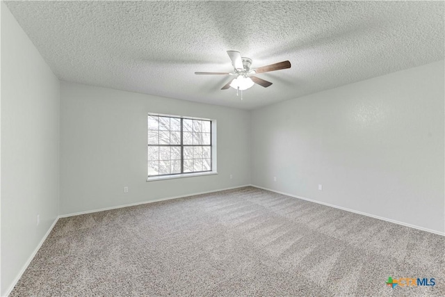 spare room featuring carpet flooring, a ceiling fan, baseboards, and a textured ceiling