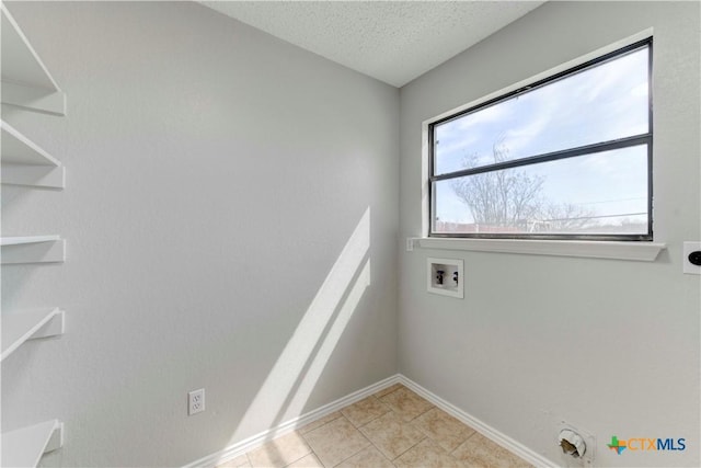 laundry area with light tile patterned floors, laundry area, hookup for a washing machine, electric dryer hookup, and a textured ceiling