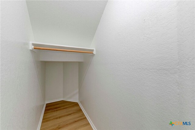 spacious closet with wood finished floors