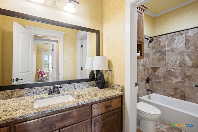 full bathroom featuring tile patterned floors, vanity, tiled shower / bath combo, crown molding, and toilet