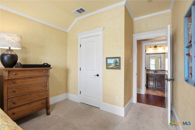 bedroom featuring sink, ornamental molding, light carpet, and vaulted ceiling