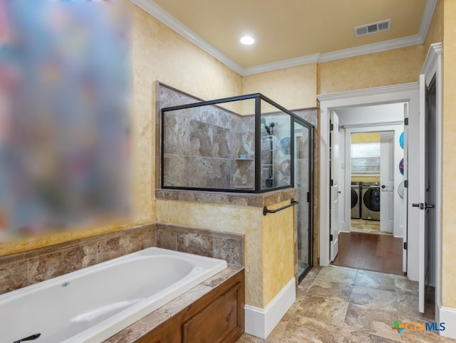 bathroom featuring independent washer and dryer, shower with separate bathtub, and crown molding