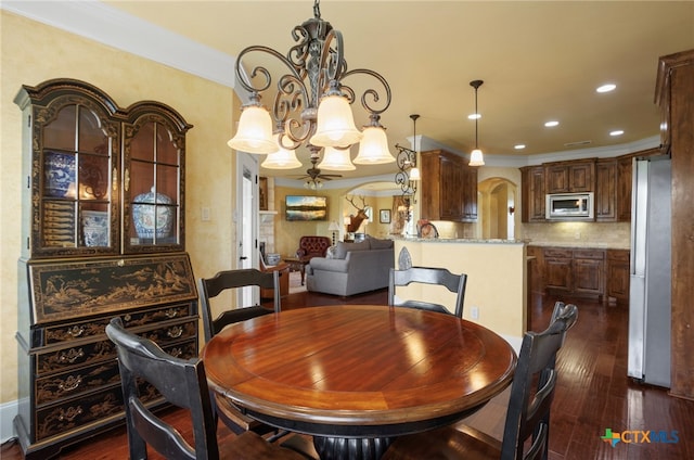 dining room with a chandelier, dark hardwood / wood-style floors, and crown molding