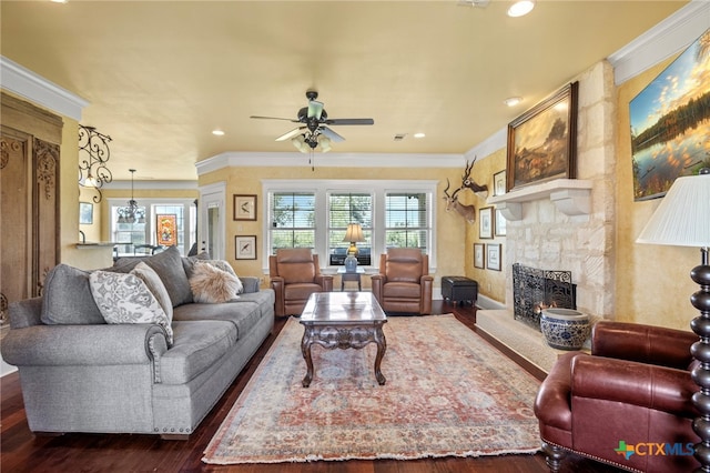 living room with a fireplace, ceiling fan, dark hardwood / wood-style flooring, and ornamental molding