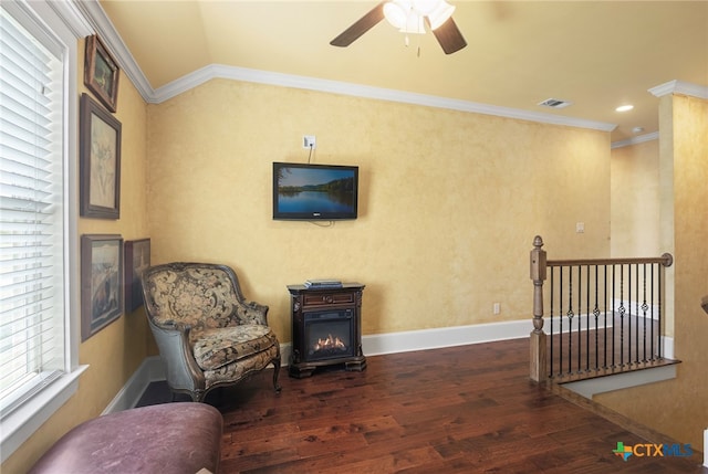 living area with ceiling fan, dark hardwood / wood-style flooring, and ornamental molding