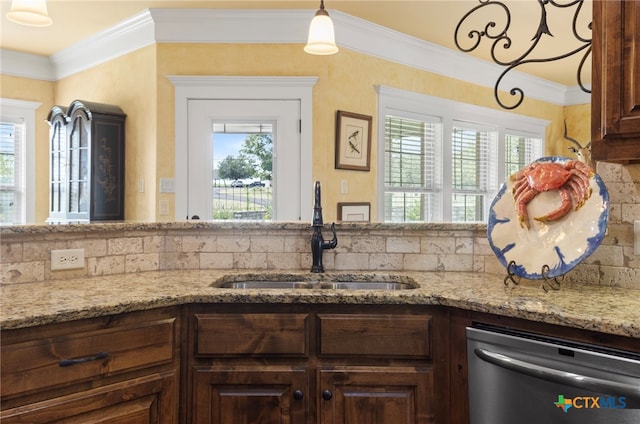 kitchen featuring decorative backsplash, light stone countertops, stainless steel dishwasher, crown molding, and sink