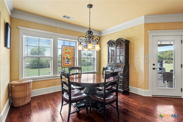 dining room featuring dark hardwood / wood-style floors, plenty of natural light, crown molding, and a chandelier