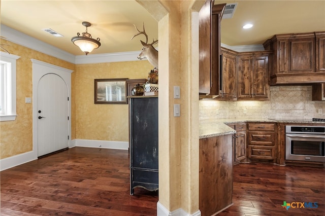 kitchen featuring dark wood-type flooring, oven, crown molding, light stone countertops, and black electric cooktop