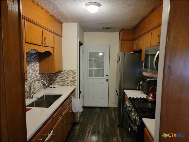 kitchen with visible vents, gas range, stainless steel microwave, dark wood-type flooring, and a sink