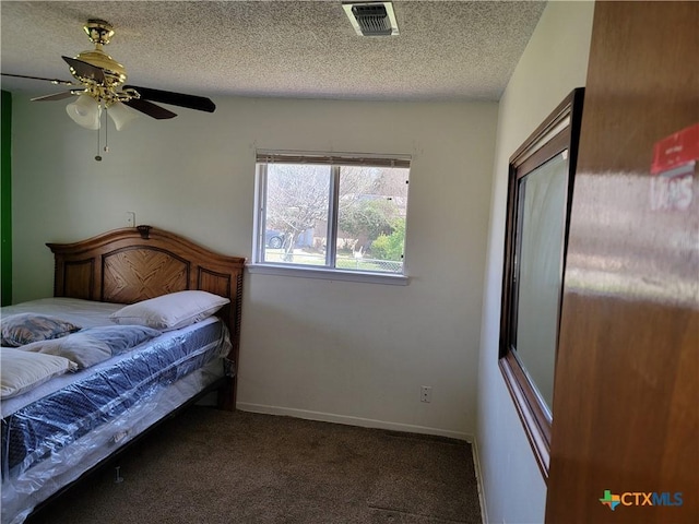 bedroom featuring carpet, visible vents, ceiling fan, a textured ceiling, and baseboards