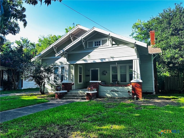 205 Coke St, Yoakum, TX 77995 - view of front of home with a porch and a chimney