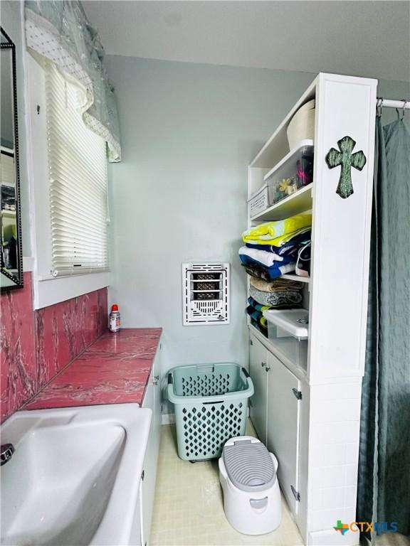 205 Coke St, Yoakum, TX 77995 - bathroom featuring heating unit and a sink