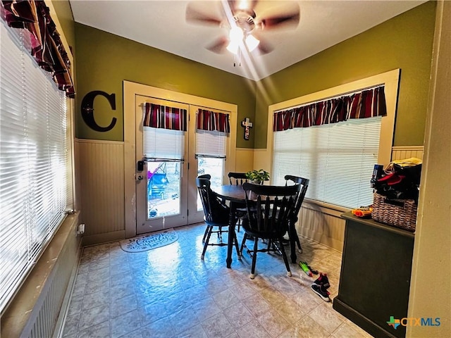 205 Coke St, Yoakum, TX 77995 - dining area with a wainscoted wall, a ceiling fan, and wood walls
