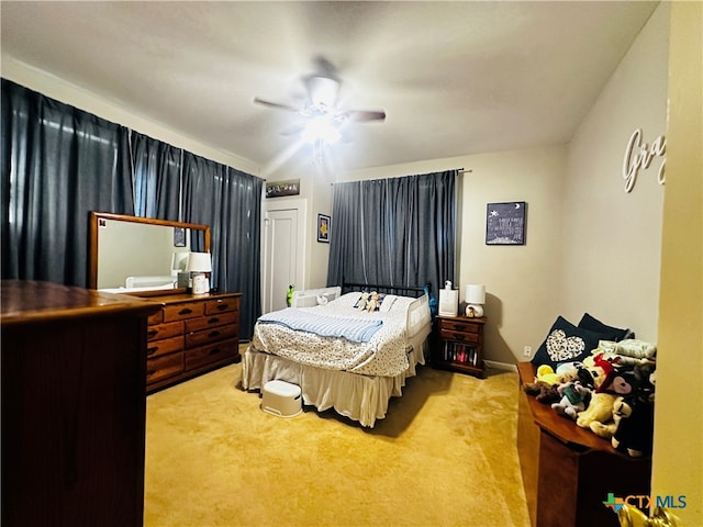 carpeted bedroom with ceiling fan