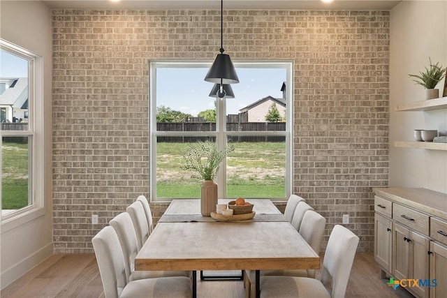 227 Glenview Cir, Belton, TX 76513 - dining room featuring light wood-style floors, plenty of natural light, brick wall, and baseboards