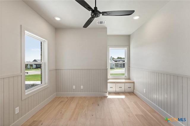 227 Glenview Cir, Belton, TX 76513 - empty room featuring light wood-type flooring, a wainscoted wall, plenty of natural light, a ceiling fan, and baseboards