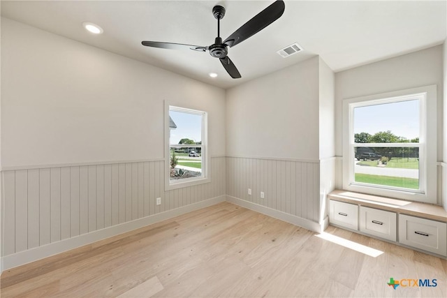 227 Glenview Cir, Belton, TX 76513 - spare room featuring light wood finished floors, a wainscoted wall, a ceiling fan, plenty of natural light, and recessed lighting