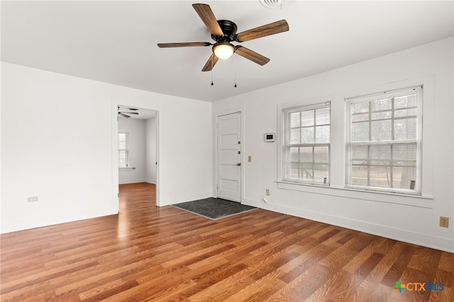 foyer featuring plenty of natural light, baseboards, and wood finished floors