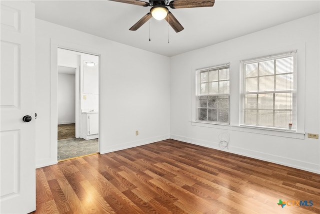 unfurnished room with ceiling fan, baseboards, and wood finished floors