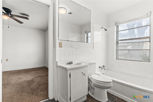 full bathroom with ceiling fan, shower / tub combination, toilet, vanity, and tile walls