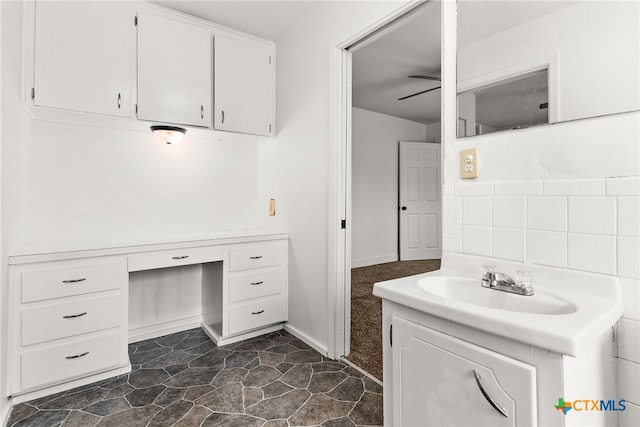 bathroom featuring vanity, a ceiling fan, and tile walls