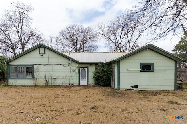 rear view of house with metal roof