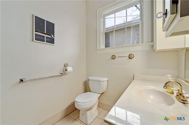 bathroom featuring toilet, tile patterned flooring, baseboards, and vanity