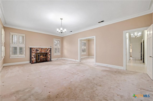 unfurnished living room with a fireplace with flush hearth, a chandelier, crown molding, and light colored carpet