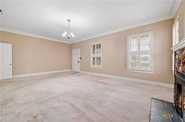 unfurnished living room with a warm lit fireplace, ornamental molding, baseboards, and an inviting chandelier